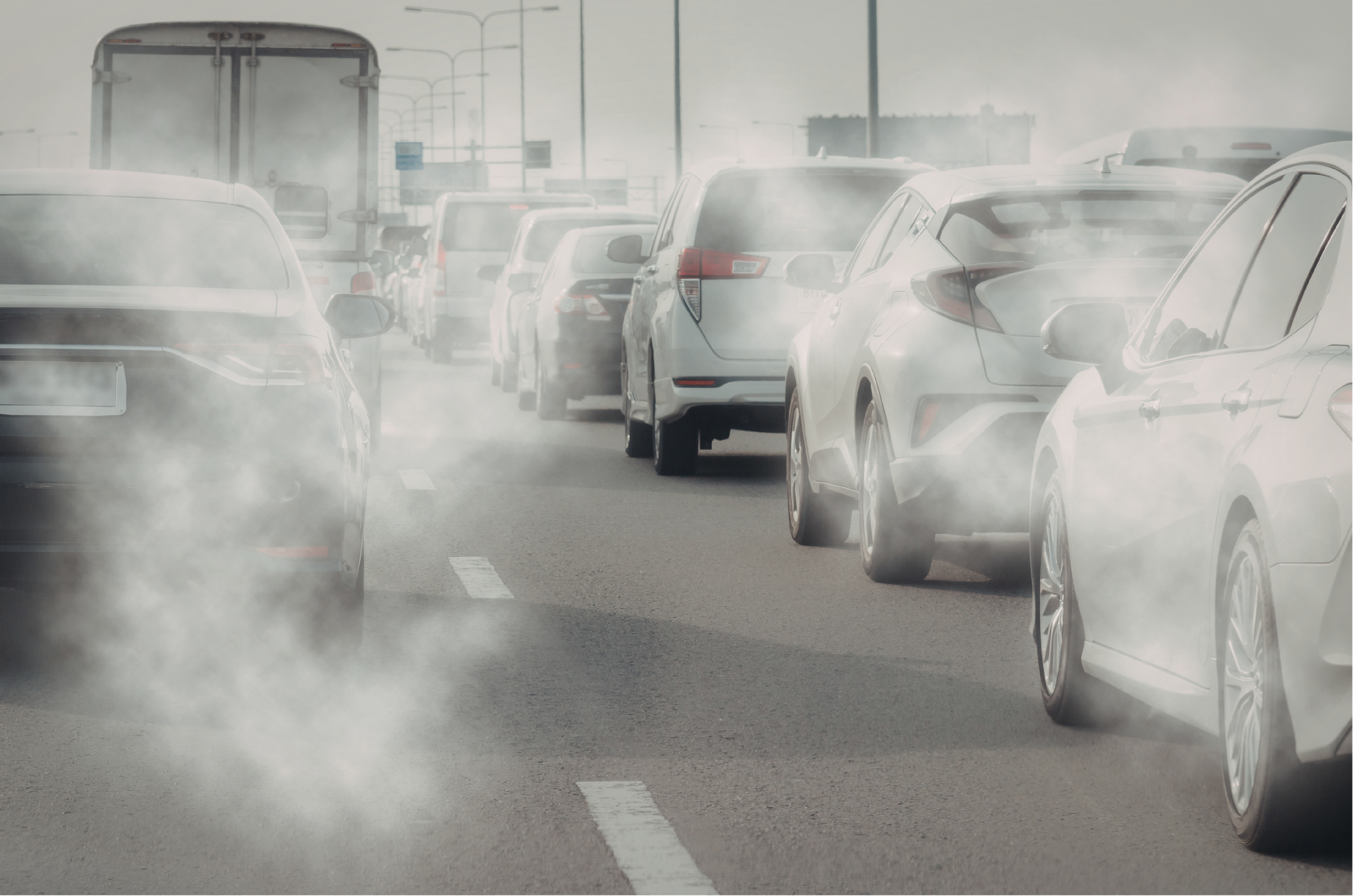 cars stuck in traffic with exhaust fumes floating in the air.
