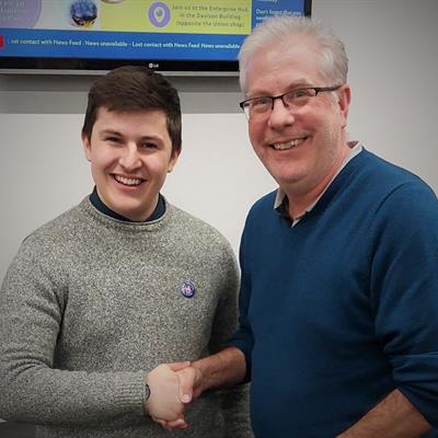 Conner Barker shaking hands with Andy Ward