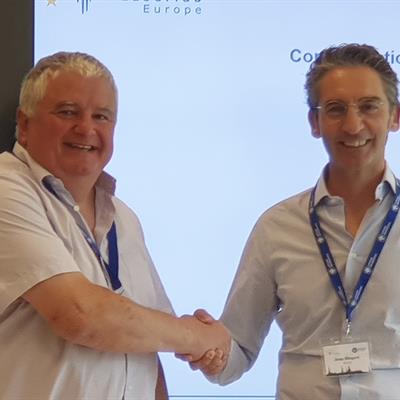 John Collier (left) and Jens Biegert (right) shake hands.