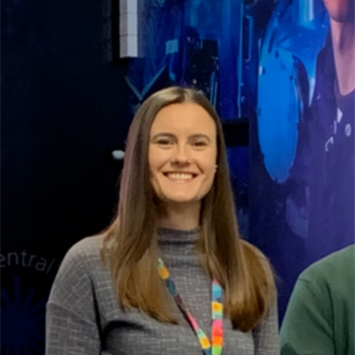 woman with brown hair beams at the camera