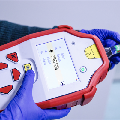 Hand-held SORS device examining a vaccine vial.