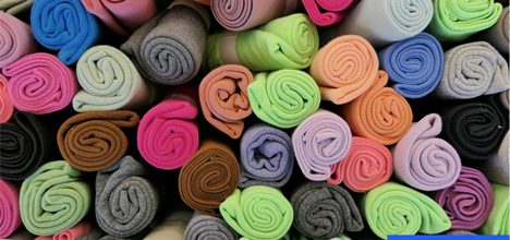 rolls of different colours fabrics. Credit: Canva
