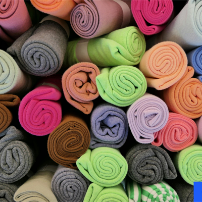 rolls of different colours fabrics. Credit: Canva