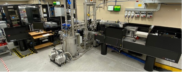DiPOLE100Hz laser system. A set of black and chrome machinery inside a lab.