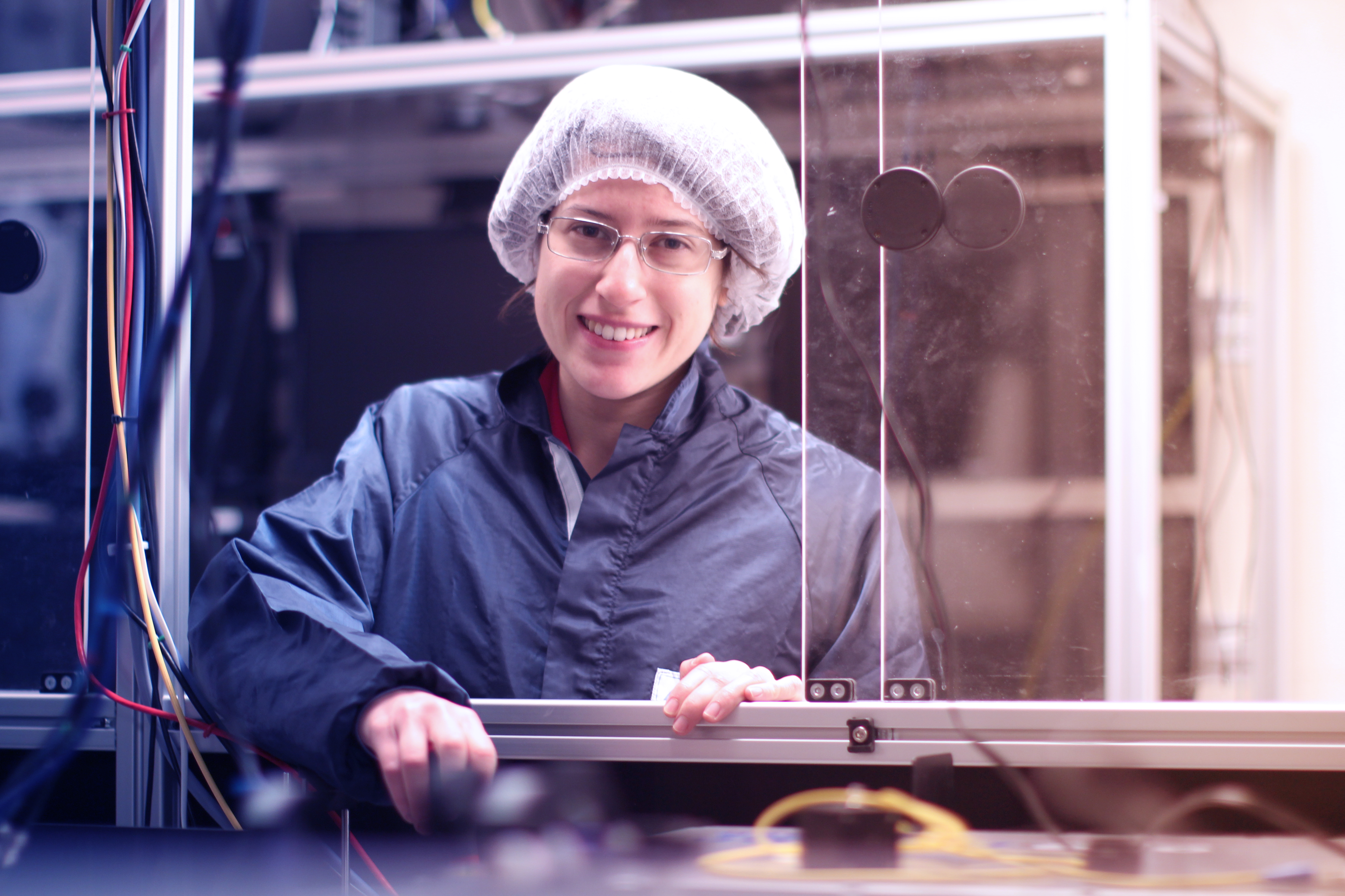 scientist stands in her laser lab