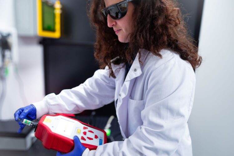 Lead author Dr Sara Mosca examining a vaccine vial.