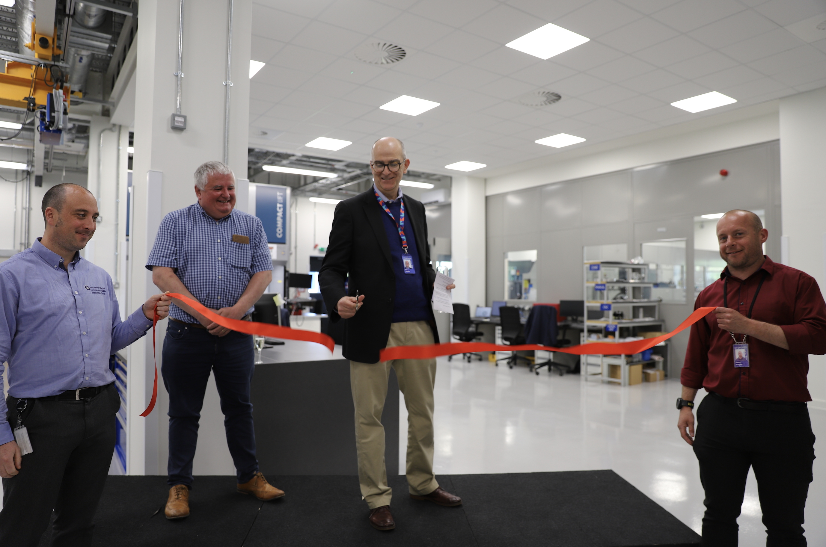 Neil Geddes cuts a red ribbon.