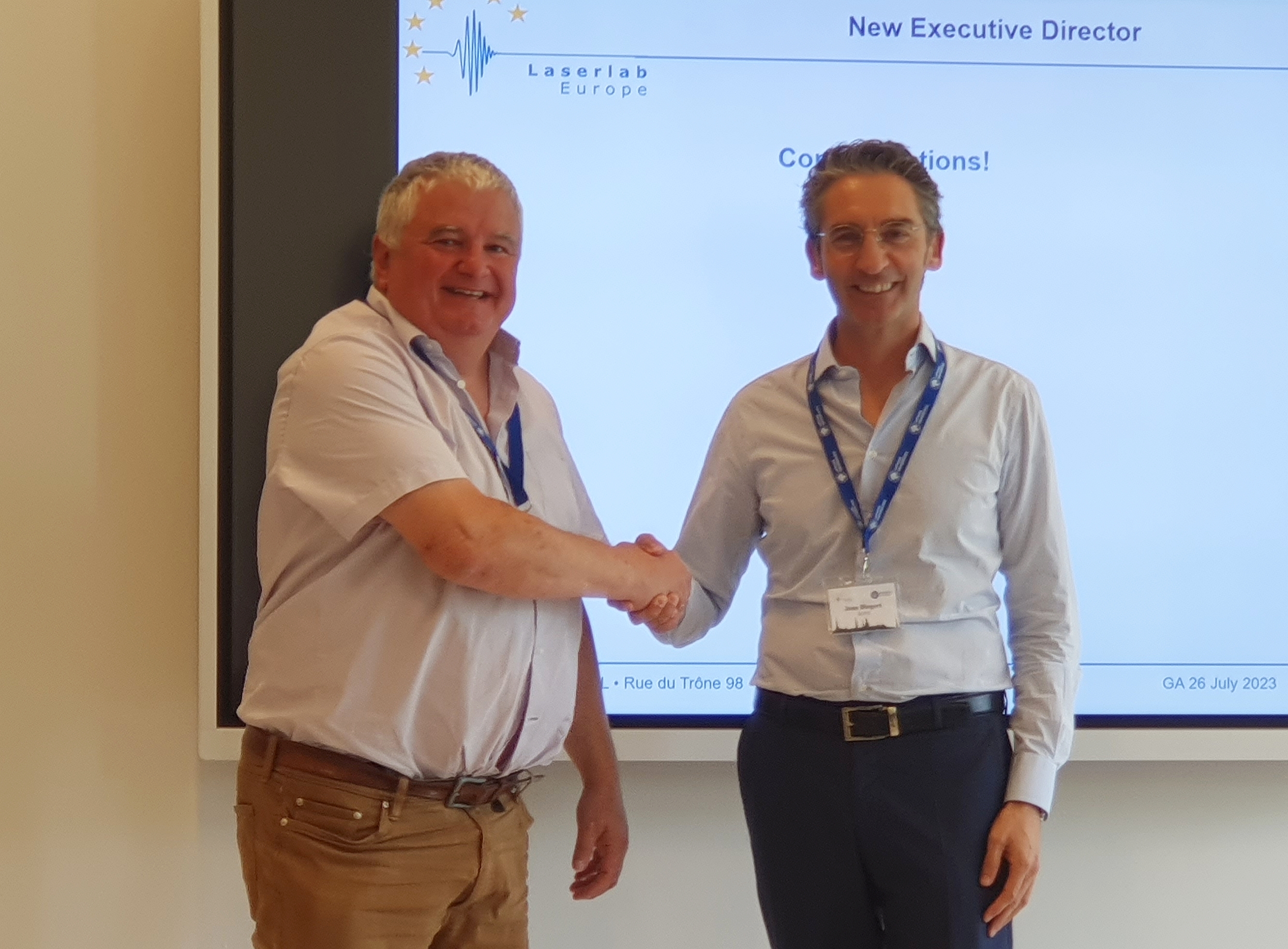 John Collier (left) and Jens Biegert (right) shake hands.